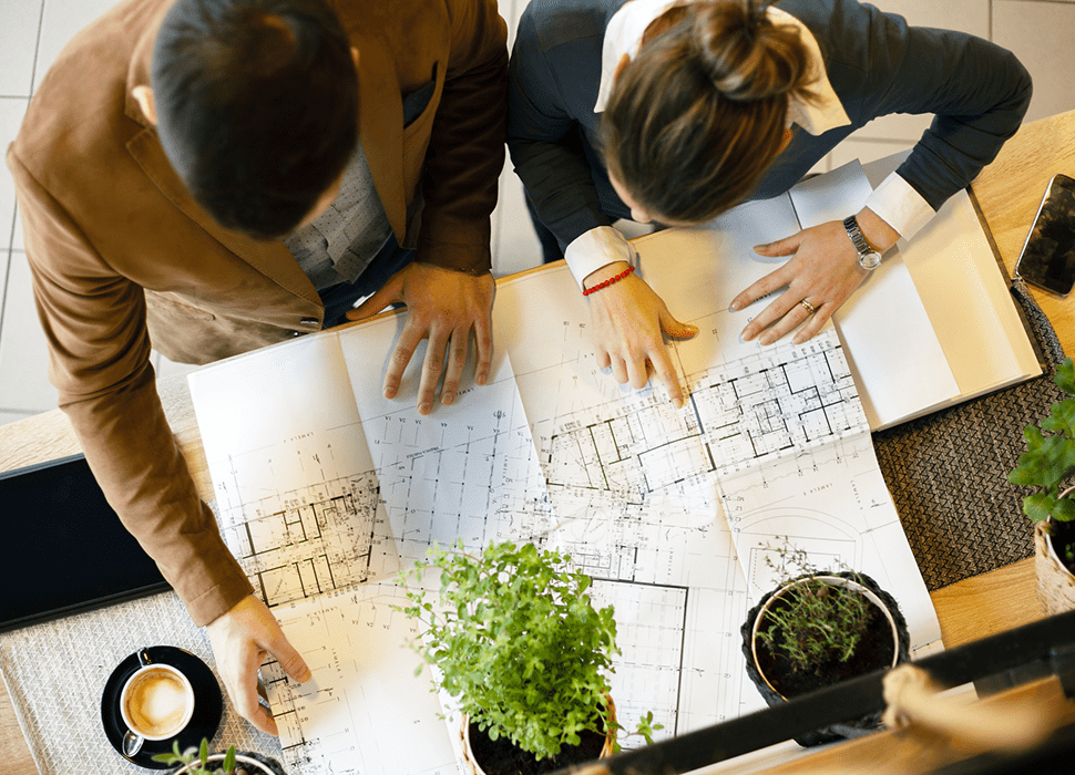 Colleagues discussing floor plans and design