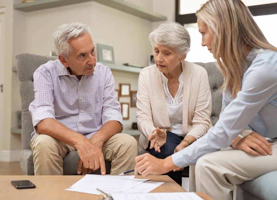 Elderly couple reviewing documents with consultant